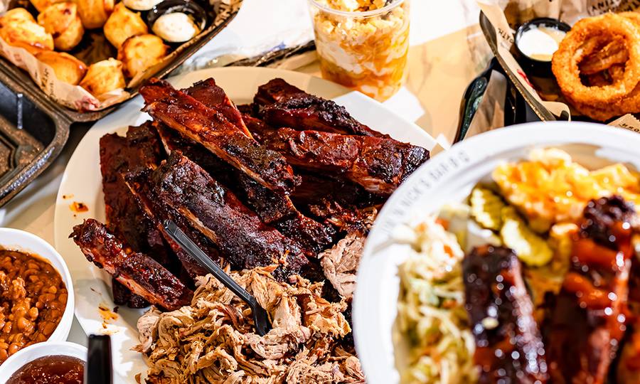 Pickup catering spread with barbecue meats and sides